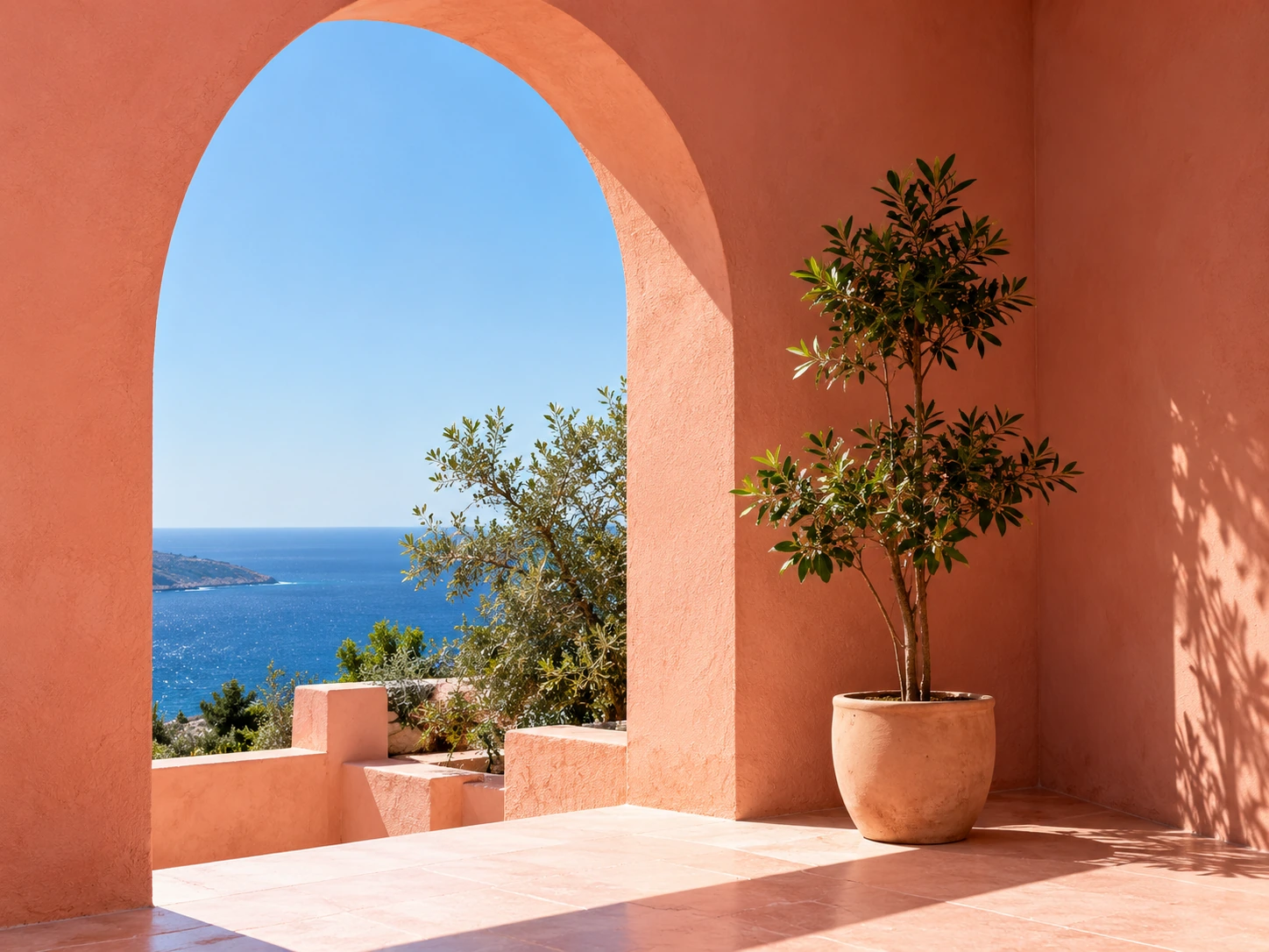 Terracotta arch and potted tree framing a distant sea view
